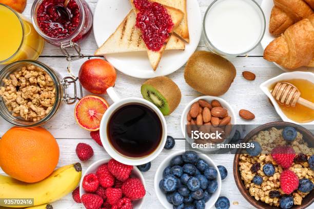 Breakfast Served With Coffee Orange Juice Toasts Croissants Cereals Milk Nuts And Fruits Balanced Diet Stock Photo - Download Image Now