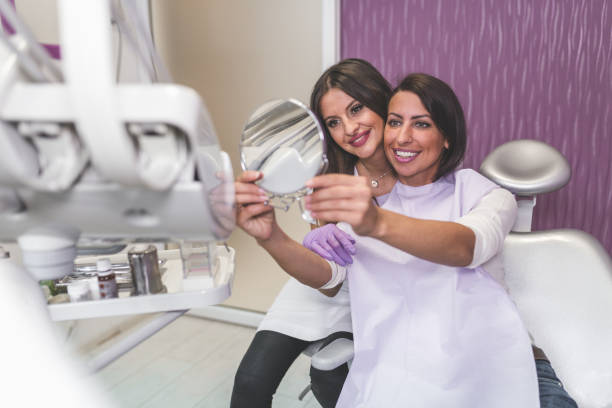 istock Happy woman at the dentist's office having a check-up 935702604