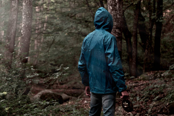 istock Man in jungle with blue coat hood 935711956