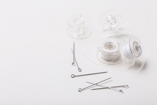 Thread Bobbin Pin Sewing Pins And Plastic Bobbin With White Threads Stock Photo ...