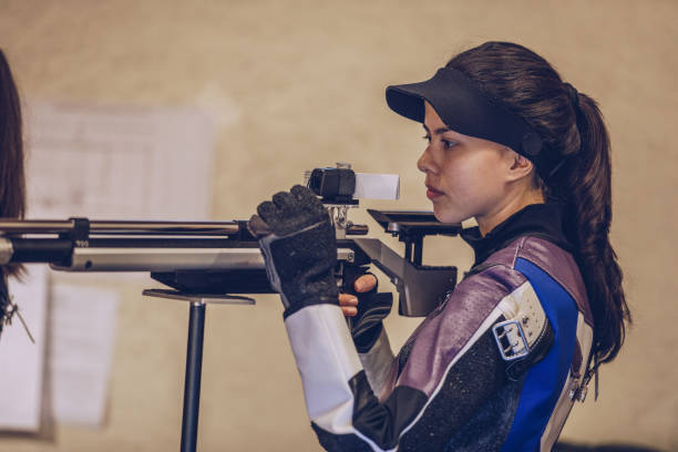 istock Young pretty woman shoots at the shooting range 935718174