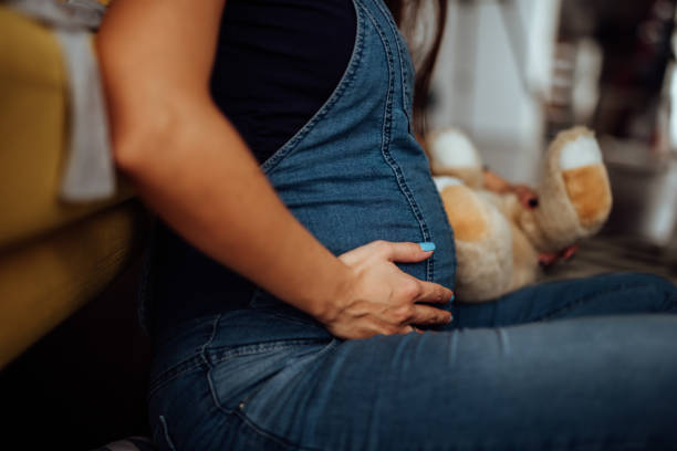 istock Future mom holding her prenant belly 935718488