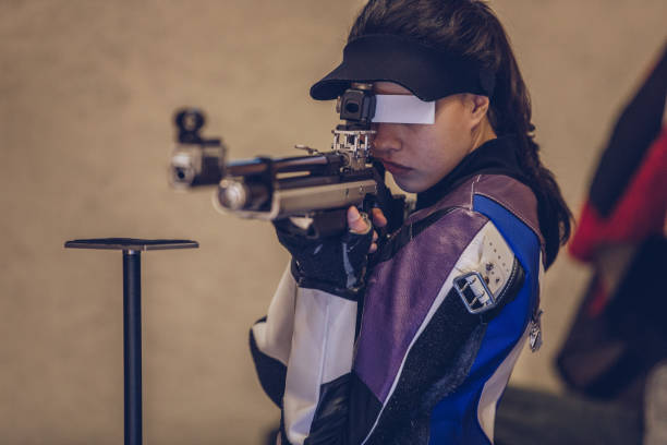 istock Young pretty woman at the shooting range 935718762