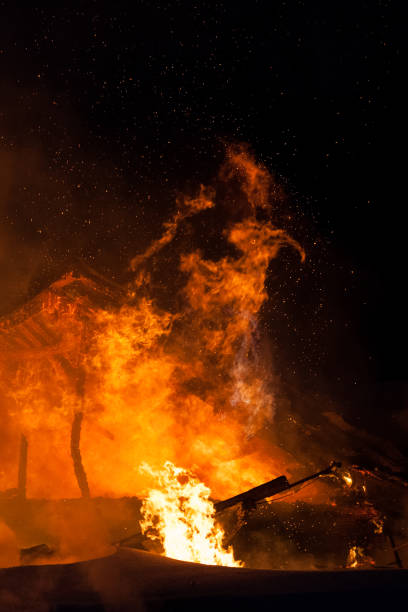istock Burning fire flame on wooden house roof 935722818