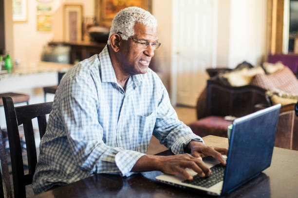 집에서 노트북 컴퓨터에서 작업 하는 수석 흑인 남자 - connection usa coffee cup mug 뉴스 사진 이미지