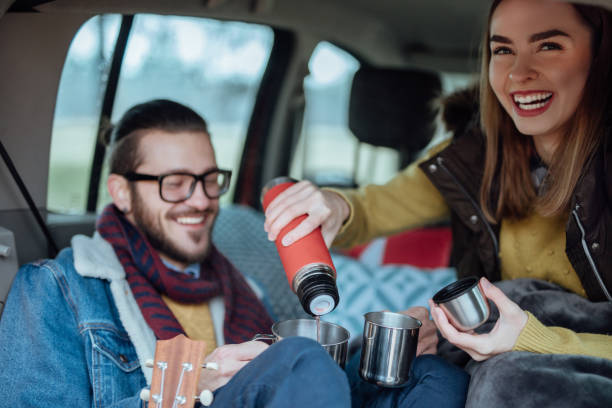 istock Happy young couple resting from their trip with hot tea 935723104