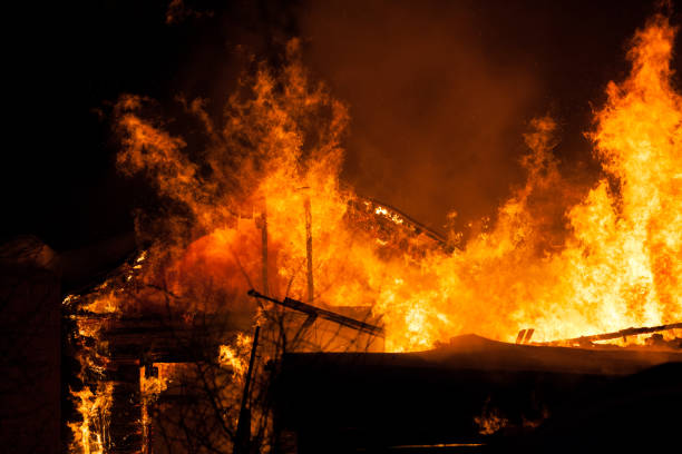 istock Burning fire flame on wooden house roof 935723138