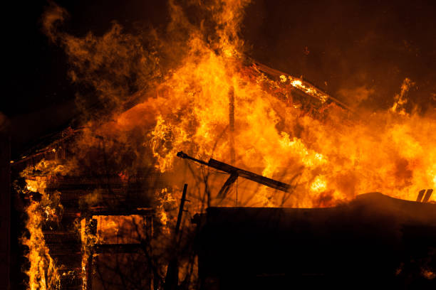 istock Burning fire flame on wooden house roof 935723184