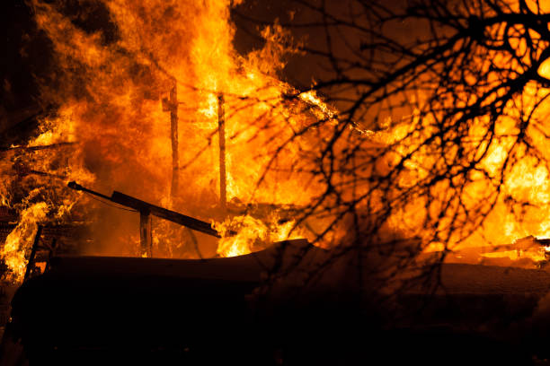 istock Burning fire flame on wooden house roof 935723260
