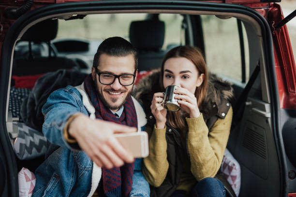 istock Happy couple taking break from their trip and drinking coffee 935725882