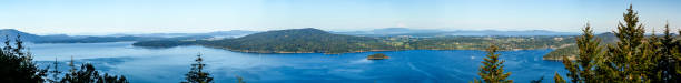 Blue water panorama of wide deep inlet between multiple islands near Vancouver island