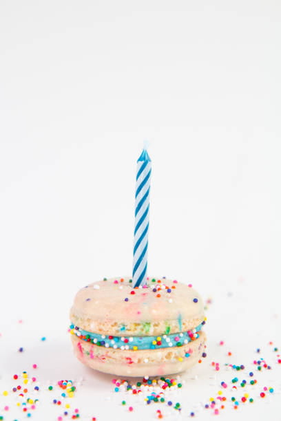 istock Funfetti Birthday Cake Macaron with a Candle 935729120
