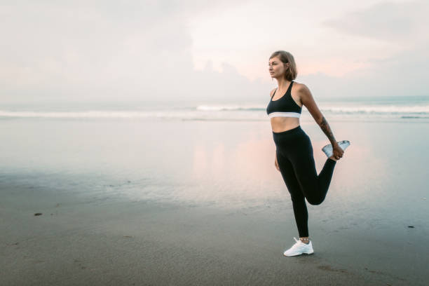istock Girl exercising on the beach 935729442