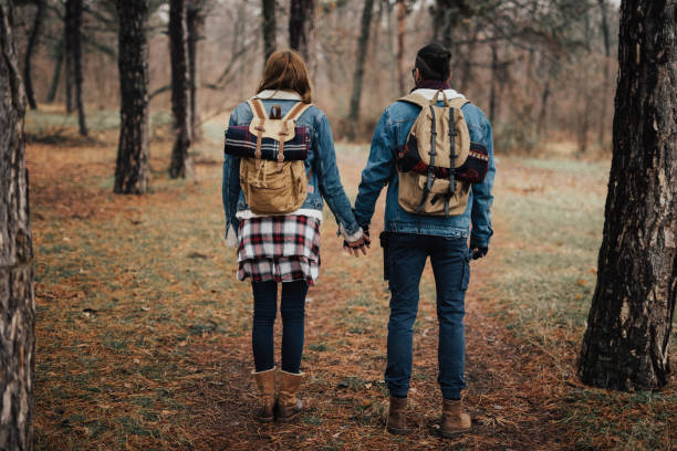istock Rear view of two hikers in the forest holding hands 935729646