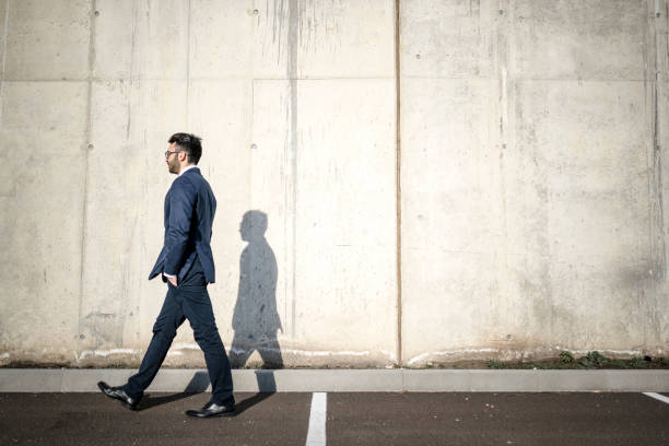 istock Lonely manager walking down the sunny street 935732348
