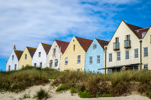 Row of houses and at Braye Beach, Alderney, Guernsey, Channel Islands