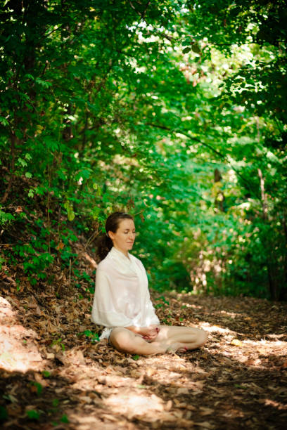istock Woman meditating in the nature 935735140