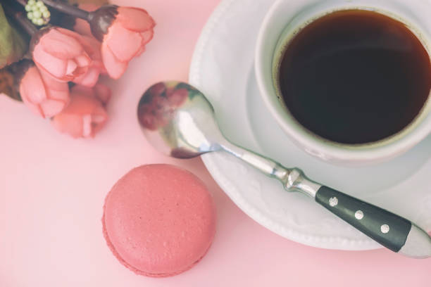 istock Pink macaron, macaroon, spring flowers and coffee, pastel background, top view. Romantic morning, gift for beloved 935735298