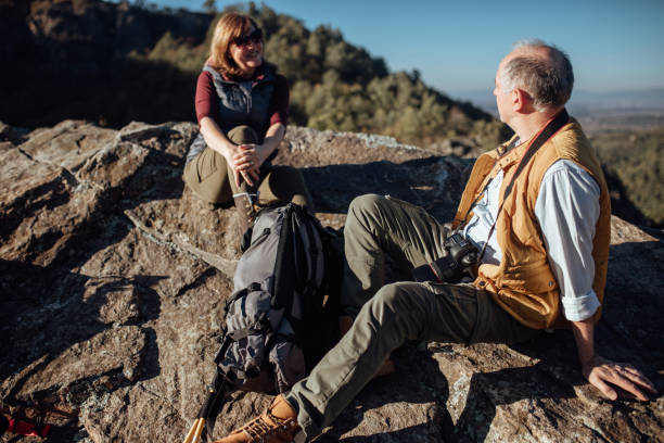istock Senior couple relaxing on the rocks from their hike 935735554
