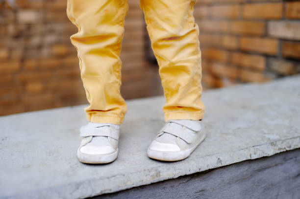 Close-up of boy legs. Little kid walking in the city. Cute child playing. Shoes for kids.