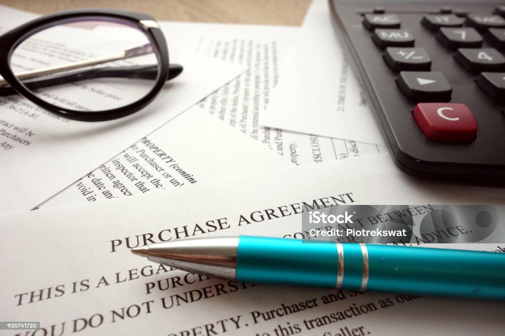 Purchase agreement Purchase agreement document for filling and signing on desk Buying Stock Photo