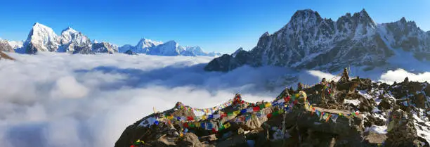 view from Gokyo Ri to Arakam Tse, Cholatse, Tabuche Peak, Thamserku and Kangtega with prayer flags - trek to Everest base camp - Nepal