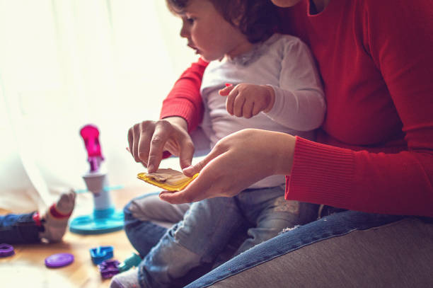 istock Mother playing with plasteline with her daughter 935754312