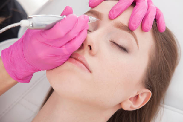 istock Close up on beautician doing permanent make up of eyebrows. Beauty treatment. 935760338