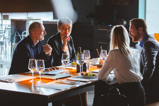 istock Group of Friends Enjoy Chatting During Lunch Time in a High-End Restaurant 935760390