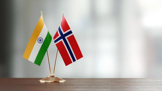 istock Indian And Norwegian Flag Pair On A Desk Over Defocused Background 935760844