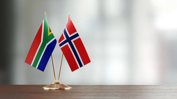 istock South African And Norwegian Flag Pair On A Desk Over Defocused Background 935768152