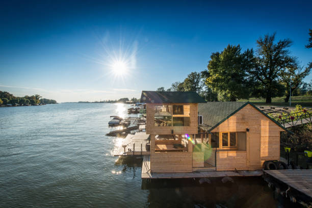 istock Wooden floath cottage on river, exterior 935770762