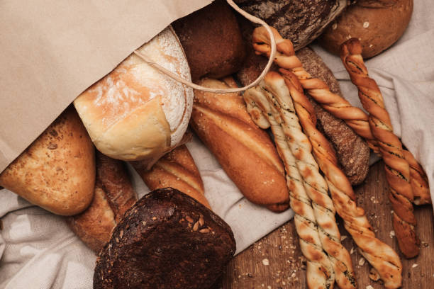istock Fragrant bread on the table in a paper bag 935771214