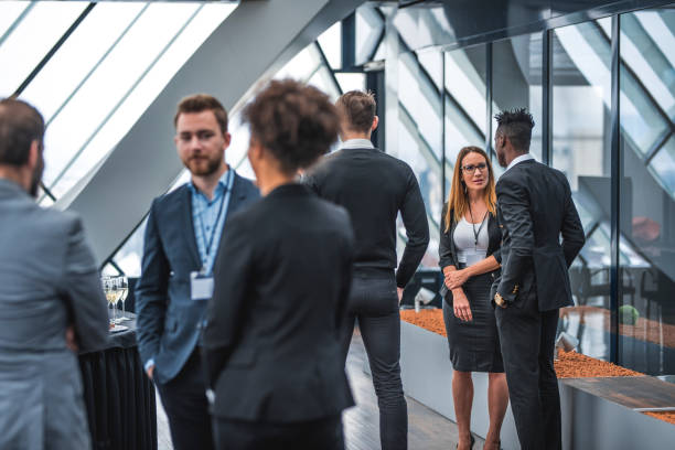 istock Businessmen and businesswoman having conversation during a break 935774670