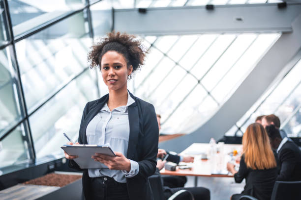 istock Businesswomen holding papers and looking at camera 935777148