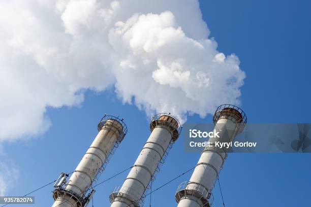 Smoking Pipes Making Clouds Against Blue Sky Background Dioxide Air Contamination Environmental Pollution Stock Photo - Download Image Now