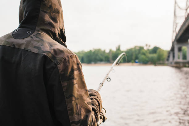 istock Fisherman fishing with a spinning on the river 935782156