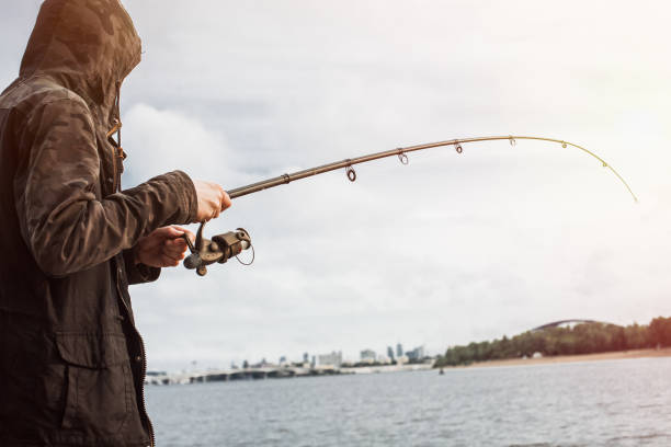 istock Fisherman fishing with a spinning on the river 935782204