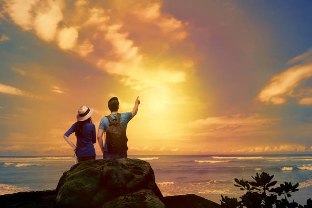 istock Lovely asian couple looking at sunset panorama 935782302