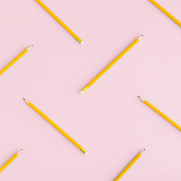 istock Straggled pencils on pink background. Flat lay. 935812244