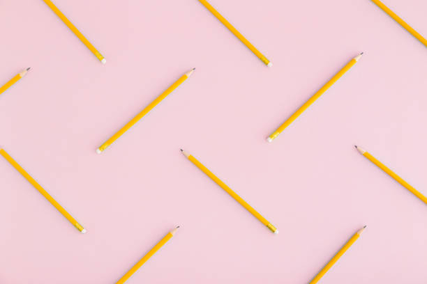 istock Flat lay with scattered pencils on pink background. 935812246