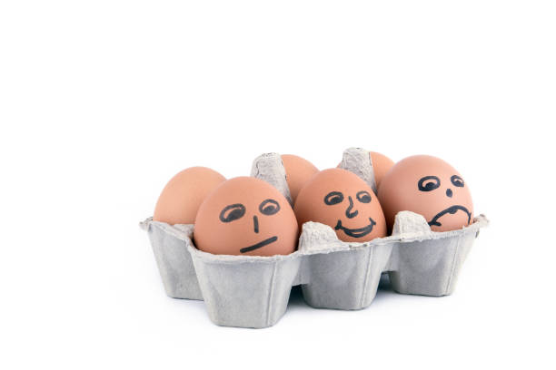 istock chicken eggs with a smile in box on white background 935815810