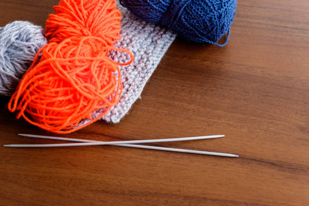 istock Woolen thread, knitting, knitting needles on wooden table 935816098