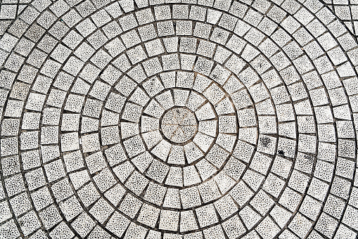 closeup paving curved circle stone brick on pathway texture, abstract and background concept