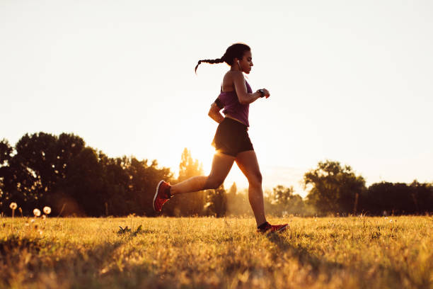 istock Girl running on the grass field 935824394
