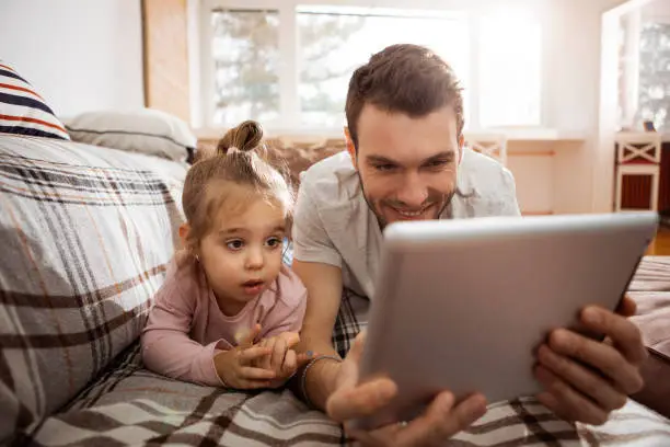 Father having fun with his child at home