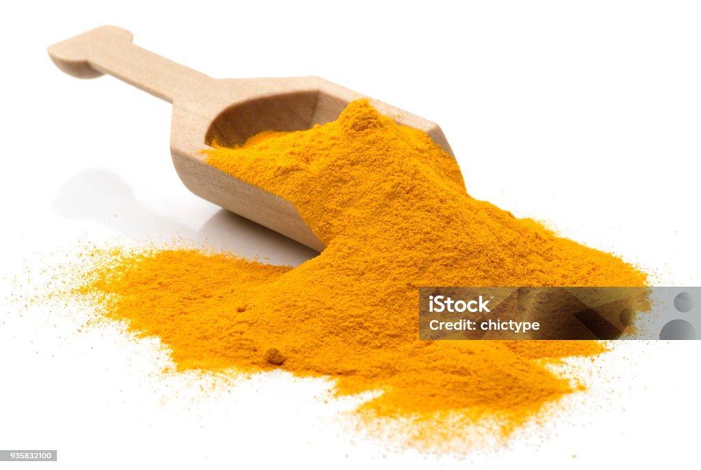 Turmeric Scoop of turmeric. 
Isolated on white. Turmeric Stock Photo