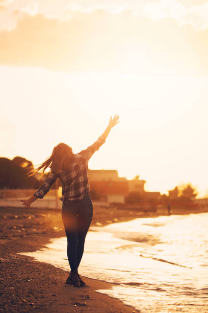 istock woman walking at sunset 935837284