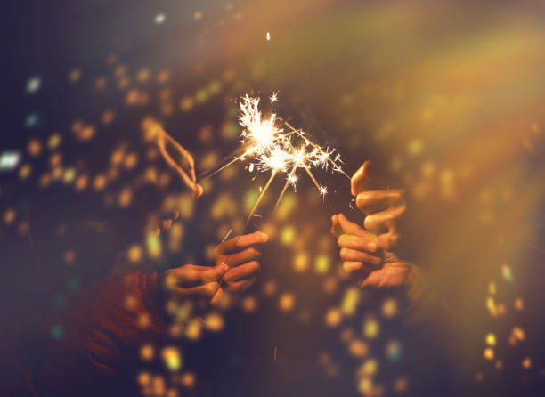 istock Picture showing group of hand having fun with sparklers. 935872142
