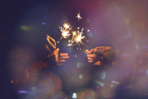 istock Picture showing group of hand having fun with sparklers. 935874302